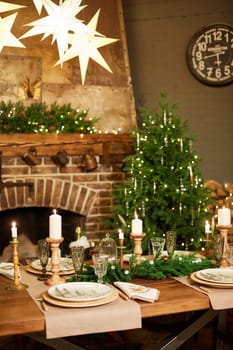 Home Christmas decoration interior late in night with light on xmas tree and fireplace.