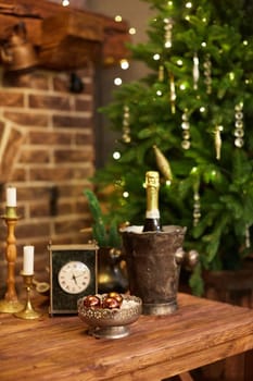 Home Christmas decoration interior late in night with light on xmas tree and fireplace.