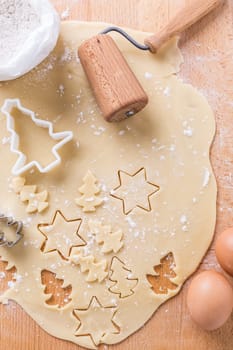 Christmas baking - dough with cookie cutter and baking ingredients. Homemade bakery, xmas sweet, winter holidays concept.