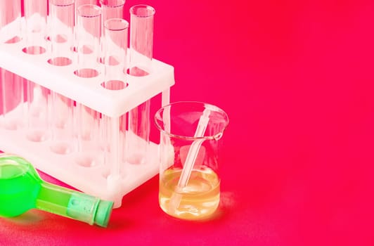 The Laboratory glassware on red background. Close up