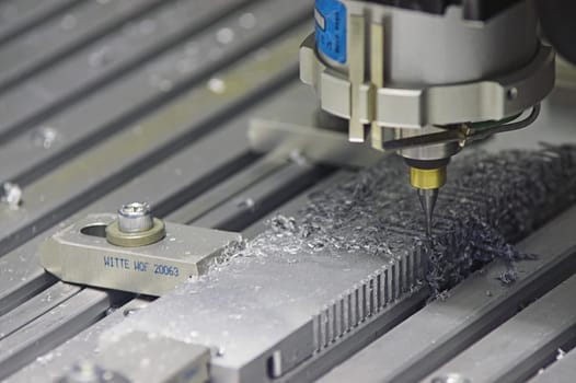 Drilling Machine automatically processing a metallic part.
