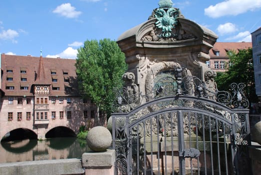 The Nuremberg Holy Spirit Hospital with the river Pegnitz seen from the museum bridge.