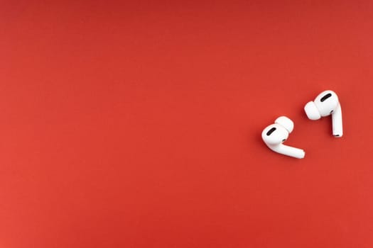 Kuala Lumpur, Malaysia - December 1,2020 : AirPods Pro on red background