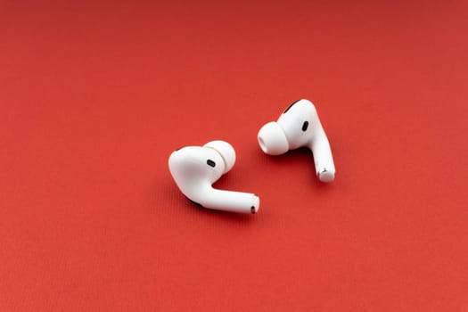 Kuala Lumpur, Malaysia - December 1,2020 : AirPods Pro on red background