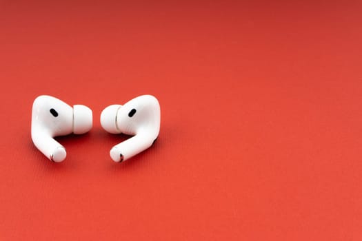 Kuala Lumpur, Malaysia - December 1,2020 : AirPods Pro on red background
