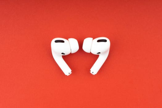 Kuala Lumpur, Malaysia - December 1,2020 : AirPods Pro on red background