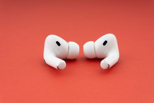 Kuala Lumpur, Malaysia - December 1,2020 : AirPods Pro on red background