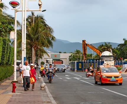 Sanya, Hainan, China- Nov 11, 2017: Central street with pedestrians and motorists