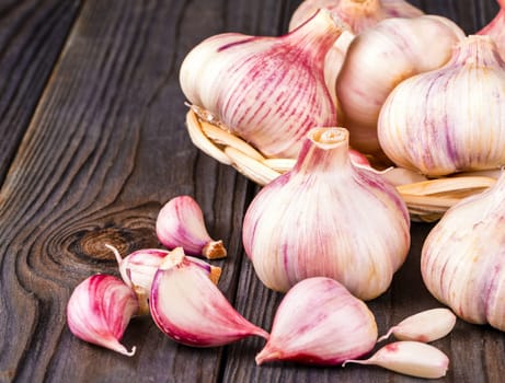The Garlic cloves and garlic bulb on a old wooden table