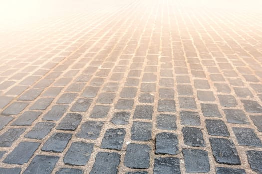 The Granite cobblestoned pavement background. Selective focus