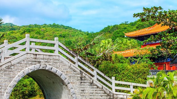 The Chinese garden with bridge and pond around the building