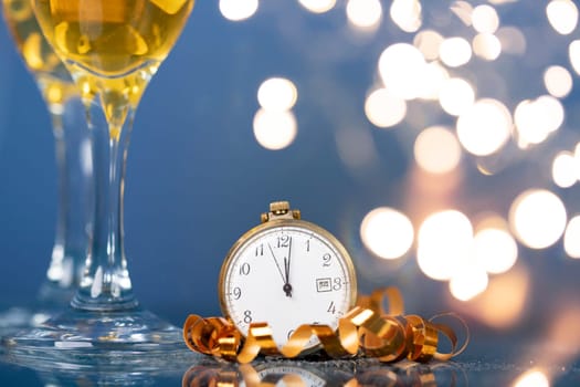 Old golden clock close to midnight, champagne and sparkling Christmas decoration - New Year concept