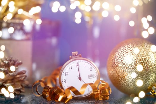 Old golden clock close to midnight, champagne and sparkling Christmas decoration - New Year concept