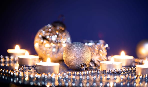 Silver Christmas balls over sparkling holiday background. Magic holiday lights. Merry Christmas and a Happy New Year