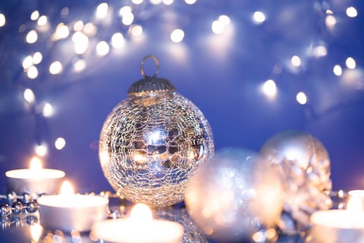 Silver Christmas balls over sparkling holiday background. Magic holiday lights. Merry Christmas and a Happy New Year