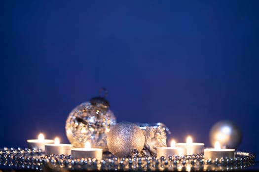 Silver Christmas balls over sparkling holiday background. Magic holiday lights. Merry Christmas and a Happy New Year