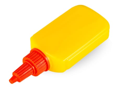 Yellow tube of glue isolated on white background