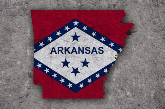 Map and flag of Arkansas on weathered concrete