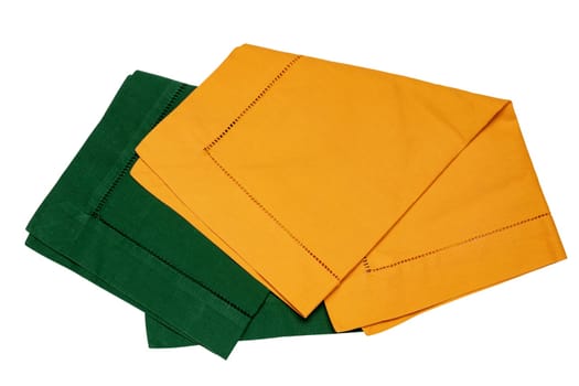 Closeup of a green and a yellow napkin or tablecloth isolated on white background. Kitchen accessories.