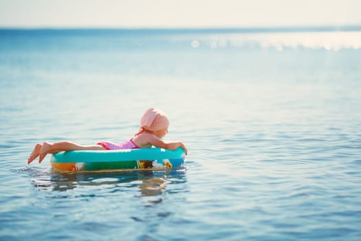 three years old girl playing at the beach in boat. Child on family vacations at sea