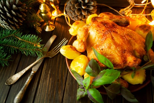 Grilled chicken with baked potato on a dark wooden holiday table