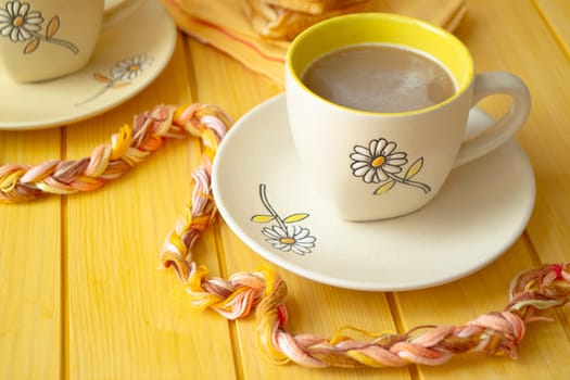 beautiful coffee yellow cup with cappuccino on yellow wooden table