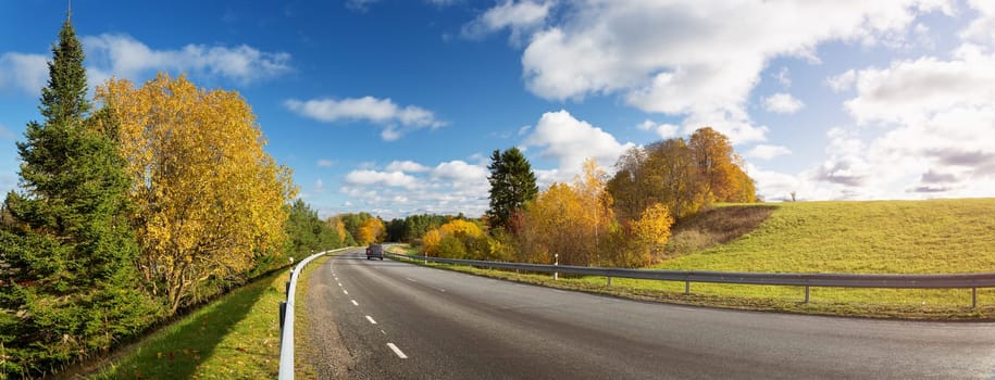 beautiful landscape on a highway in autumn. Road at falls on sunny day