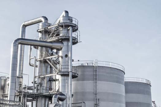 View of an industrial oil refinery with shiny tubes.