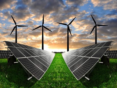 Solar energy panels with wind turbines in the sunset