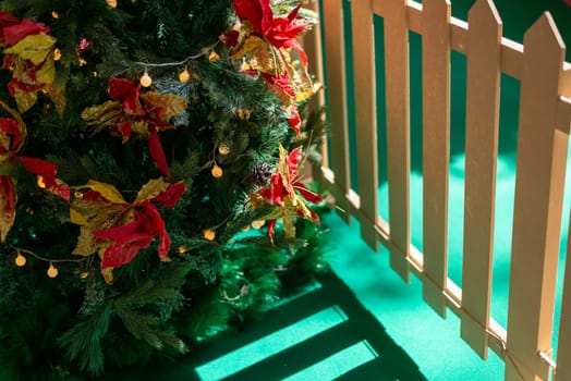 Morning light shadow over the fence at decoration christmas tree.