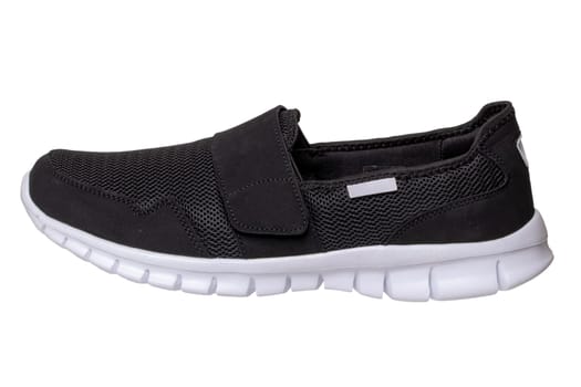 Mans black shoes. Close-up of a single black sneaker or sport shoe isolated on a white background. Clipping path included. Elegant and trendy mens footwear. Macro.