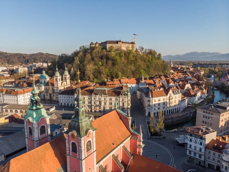 Aerial drone panoramic view of Ljubljana, capital of Slovenia in warm afternoon sun.