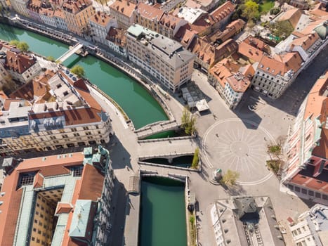 Aerial drone view of Preseren Squere and Triple Bridge over Ljubljanica river,Tromostovje, Ljubljana, Slovenia. Empty streets during corona virus pandemic social distancing measures.