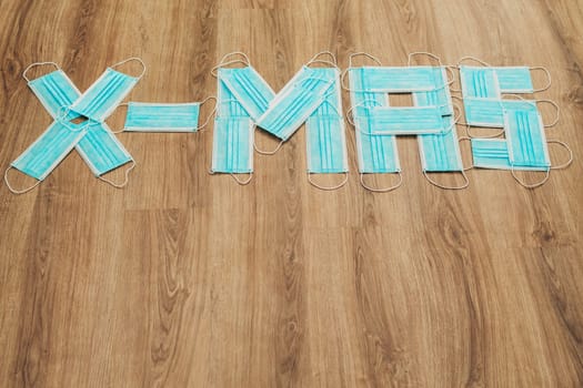 Capital Letters Happy Composed of Medical Masks on a Brown Background with Copy Space