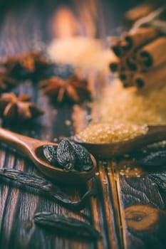 Fragrant spices for Christmas baking on wooden background.