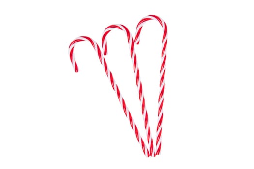 Pastries, desserts and sweets. Traditional Christmas red and white striped candy canes isolated on a white background. Top view.