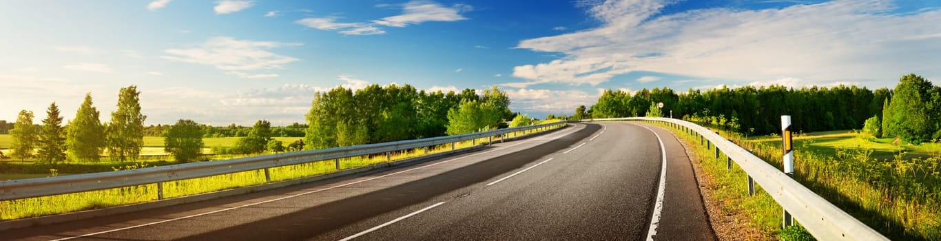 asphalt road panorama in countryside on sunny spring evening