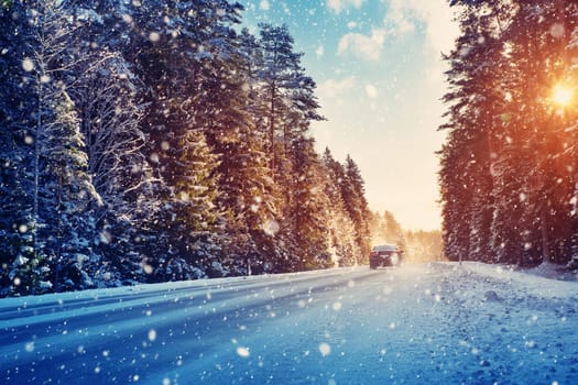 Car tires on winter road covered with snow