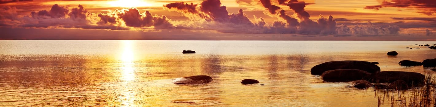 sunset at the sea with beautiful orange water and clouds