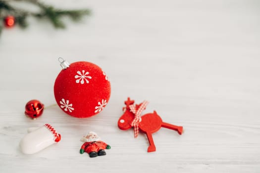 Christmas Red Decorations on a White Wooden Table with Copy Space Text