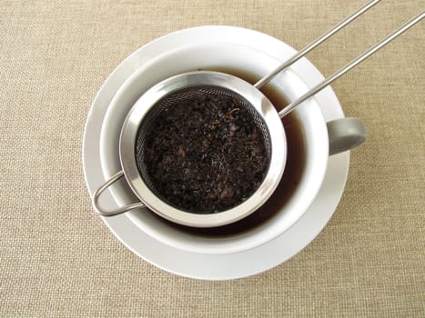 Black tea in a tea sieve