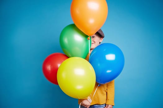 Portrait of a little boy holding balloons