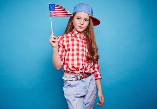 Beautiful girl holding American flag on a stick
