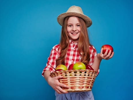 Smiling girl keeping fruit basket
