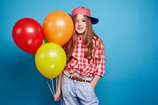 Smiling girl keeping balloons in her hand