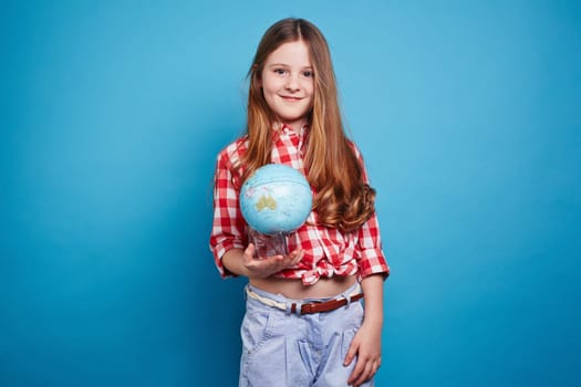 Clever girl keeping a small globe
