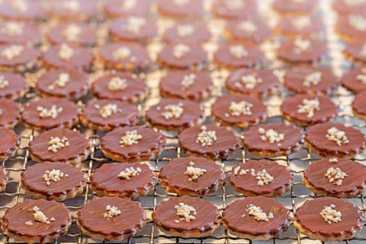 Brown Christmas cookies lie on a plate as a background