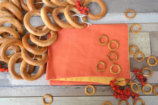Traditional russian small and big bagels or baranki and sushki on rustic table background, flat lay