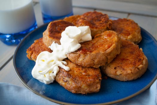 homemade delicious pancakes of buckwheat flour served with sour cream. Gourmet and healthy breakfast. backgound for Maslenitsa or Mardi gras