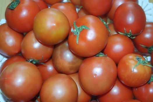 Close-up view of red tomatoes in market for sale. A fruit background for text and advertisements